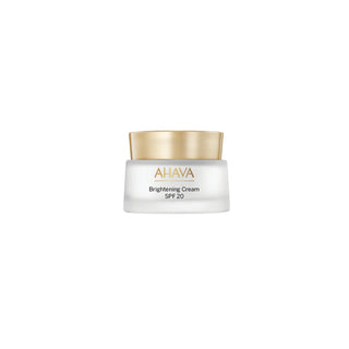 AHAVA Brightening Cream SPF 20 in a frosted glass jar with a metallic gold lid, centered on a solid white background.