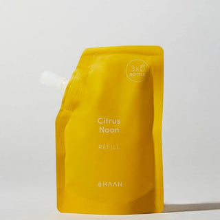 A bright yellow refill pouch for Haan Citrus Noon citrus drink, featuring a white spout cap and printed text on a clean white background.