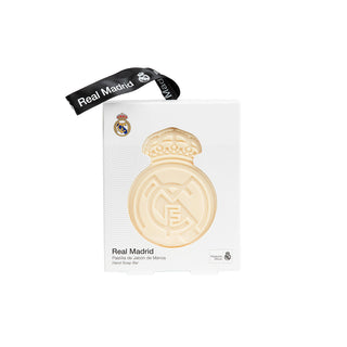 A Real Madrid 'Marc Roig Bar' chocolate bar in its white packaging, featuring a gold-colored oval logo of the bar embedded on the front, with a black Real Madrid branded ribbon attached at the top.