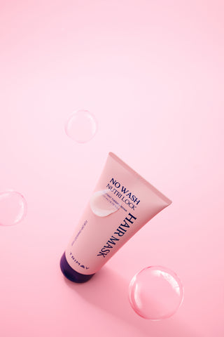 Pink skincare product with text on a pink background
