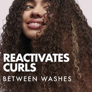 Person with curly hair and text 'Reactivates Curls Between Washes' on a pink background