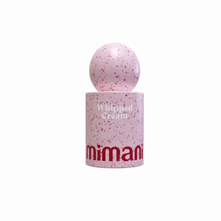 A pink cosmetic container with a matching round cap, featuring a speckled pink and white pattern. The cylindrical base is labeled 'Whipped Cream' in white text and 'mimani' in red text at the bottom.
