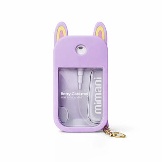 A lavender purple hair and body spray bottle by mimani, featuring a bunny-ear design on the cap and a gold keychain ring, shown on a white background.