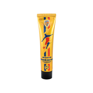 A tube of Romania national football team themed body cream, featuring a metallic gold design with blue and red graphics and a black cap, set against a plain white background.