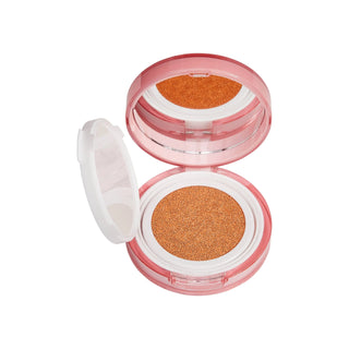 Compact makeup case with orange powder on a white background