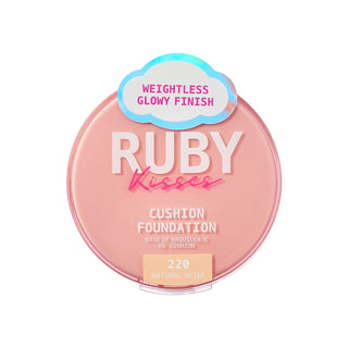 A round pink compact of Ruby Kisses Cushion Foundation in shade 220 Natural Beige, featuring a holographic cloud sticker that reads 'Weightless Glowy Finish'.