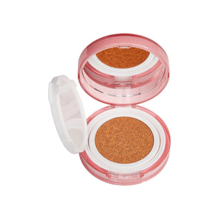 Compact makeup case with brown powder on a white background