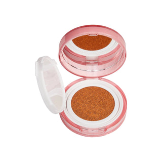 Compact makeup case with brown powder on a white background