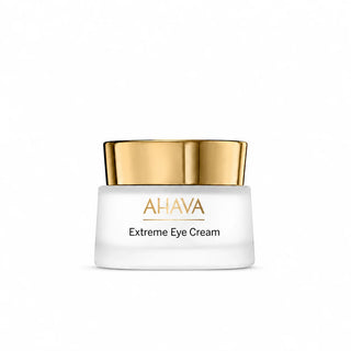 A white cosmetic jar of AHAVA Extreme Eye Cream with a shiny gold lid, centered on a clean white background.