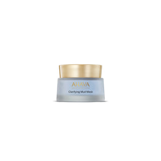 A small cosmetic jar labeled 'AHAVA Clarifying Mud Mask' with a frosted pale blue-gray body and a metallic gold lid, centered on a plain white background.