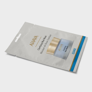 AHAVA Clearing Mud Mask cleansing packet in a light gray resealable pouch with gold and blue accents, shown on a light gray background.