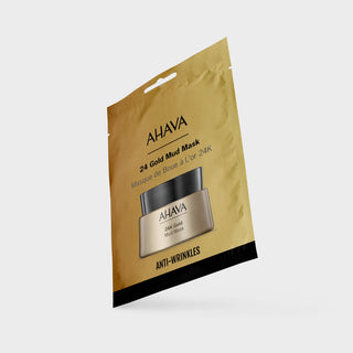 AHAVA 24 Gold Mud Mask anti-wrinkle mask in its gold foil packaging, shown floating at an angle against a light gray background.
