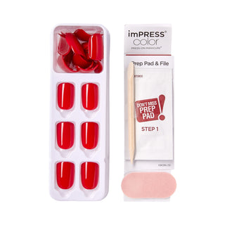 Red press-on nails with a preparation pad and file on a white background