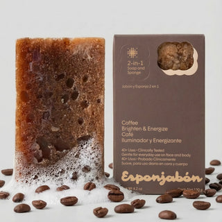 Coffee-flavored soap bar with packaging and coffee beans on a light gray background