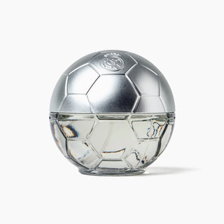 A soccer ball-shaped perfume bottle with a metallic silver cap and a clear glass lower half, featuring the Real Madrid crest on top, set against a plain white background.