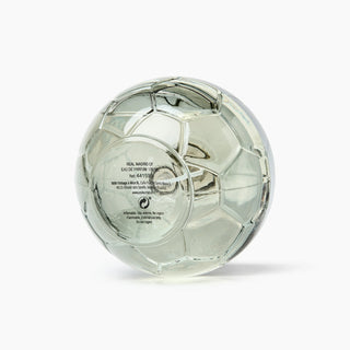 A soccer ball-shaped clear glass perfume bottle with a soccer pattern, containing a pale greenish liquid, shown on a white background.
