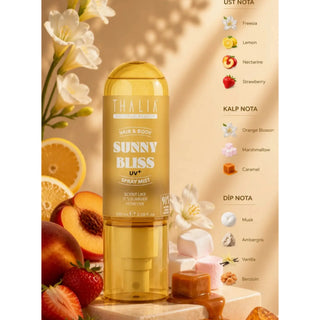 Thalia Sunny Bliss UV+ Spray Mist hair and body fragrance bottle, shown in a warm golden-yellow translucent bottle with a clear cap. The bottle is centered on a beige background with decorative peach slices, strawberries, white flowers, and a fragrance notes list on the right side.