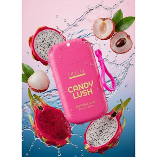 A pink THALIA Candy Lush perfume mist bottle with a matching wrist strap, surrounded by fresh dragon fruit slices, lychee, and water splashes on a pink-to-blue gradient background.