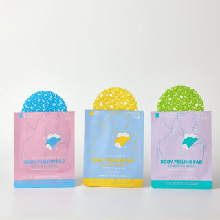Three stand-up pouches of body peeling pads are arranged side by side on a white surface against a white background. The left pouch is pink with a blue peeling pad visible, the middle is light blue with a yellow peeling pad visible, and the right is lavender with a green peeling pad visible.