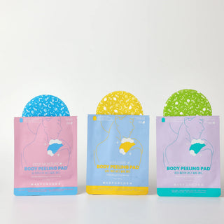 Three stand-up pouches of body peeling pads are arranged side by side on a white surface against a white background. The left pouch is pink with a blue peeling pad visible at the top, the middle pouch is light blue with a yellow peeling pad visible at the top, and the right pouch is lavender with a green peeling pad visible at the top.