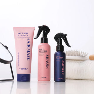 Set of Trimay hair care products including a hair mask, hair spray, and serum on a white background.