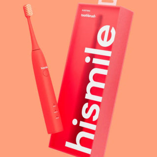 A red electric toothbrush with white bristles is shown next to its matching red packaging box featuring the brand name 'hismile' in large white letters, set against a solid peach background.