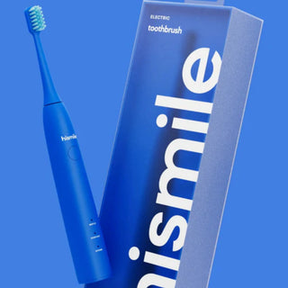 A blue electric toothbrush shown next to its matching blue packaging box with large white 'nismile' branding, set against a solid blue background.