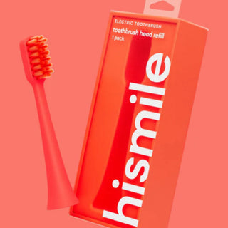 A coral-pink electric toothbrush with orange bristles shown next to its bright red-orange packaging box featuring the brand name 'hismile' in large white letters.