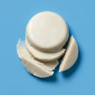 Three off-white, solid circular bars with rough, textured edges, arranged on a solid blue background.