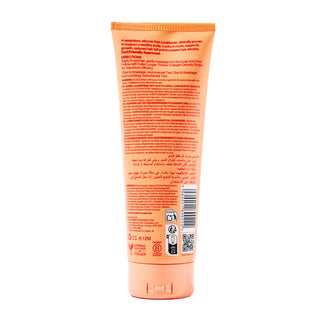 The back of an orange squeeze tube for hair conditioner, featuring detailed product information, a barcode, and certification logos on a plain white background.