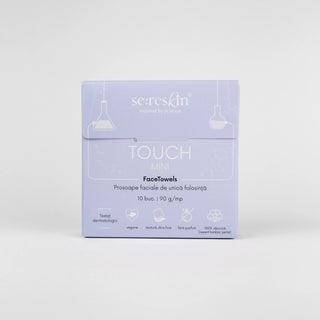 A square product box for se:reskin TOUCH MINI FaceTowels, shown against a plain light gray background. The box is a very pale lavender purple with white text and simple line drawings of hanging lamps.