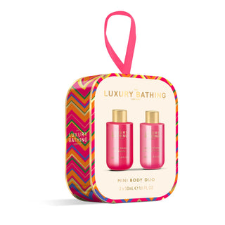 Luxury Bathing London Mini Body Duo gift set in a rounded rectangular hanging box with a pink ribbon loop. The packaging features a colorful chevron border and a cream center panel showing two pink bottles with gold caps.