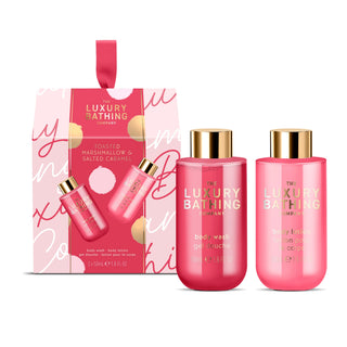 The Luxury Bathing Company body wash and body lotion gift set in a pink and white patterned box, with two pink bottles and gold caps in front on a white background.