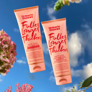 Two bottles of Umberto Giannini hair care products against a blue sky with flowers.